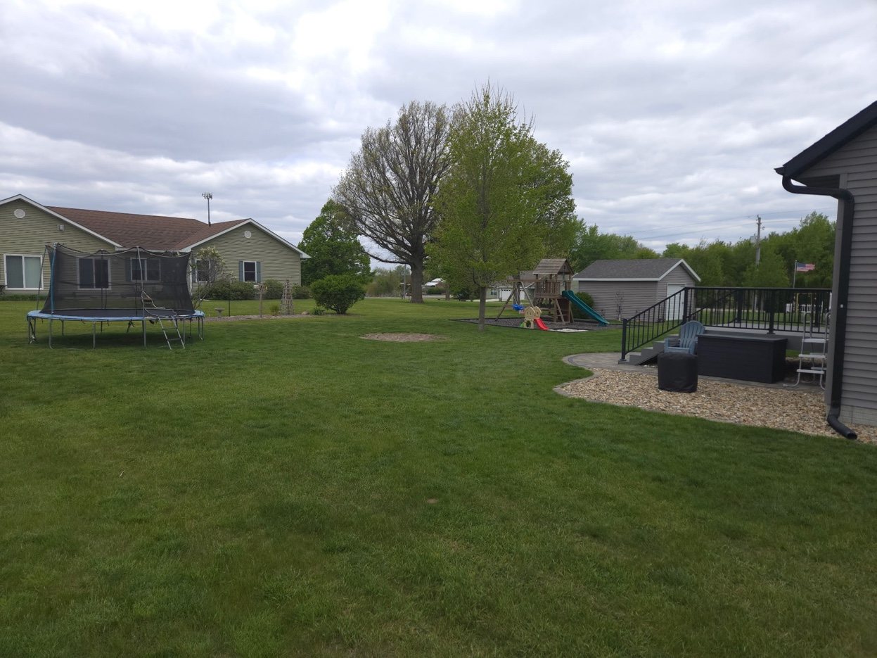 Backyard at 934 2nd Street Jesup Iowa - open lot, deck, and play area