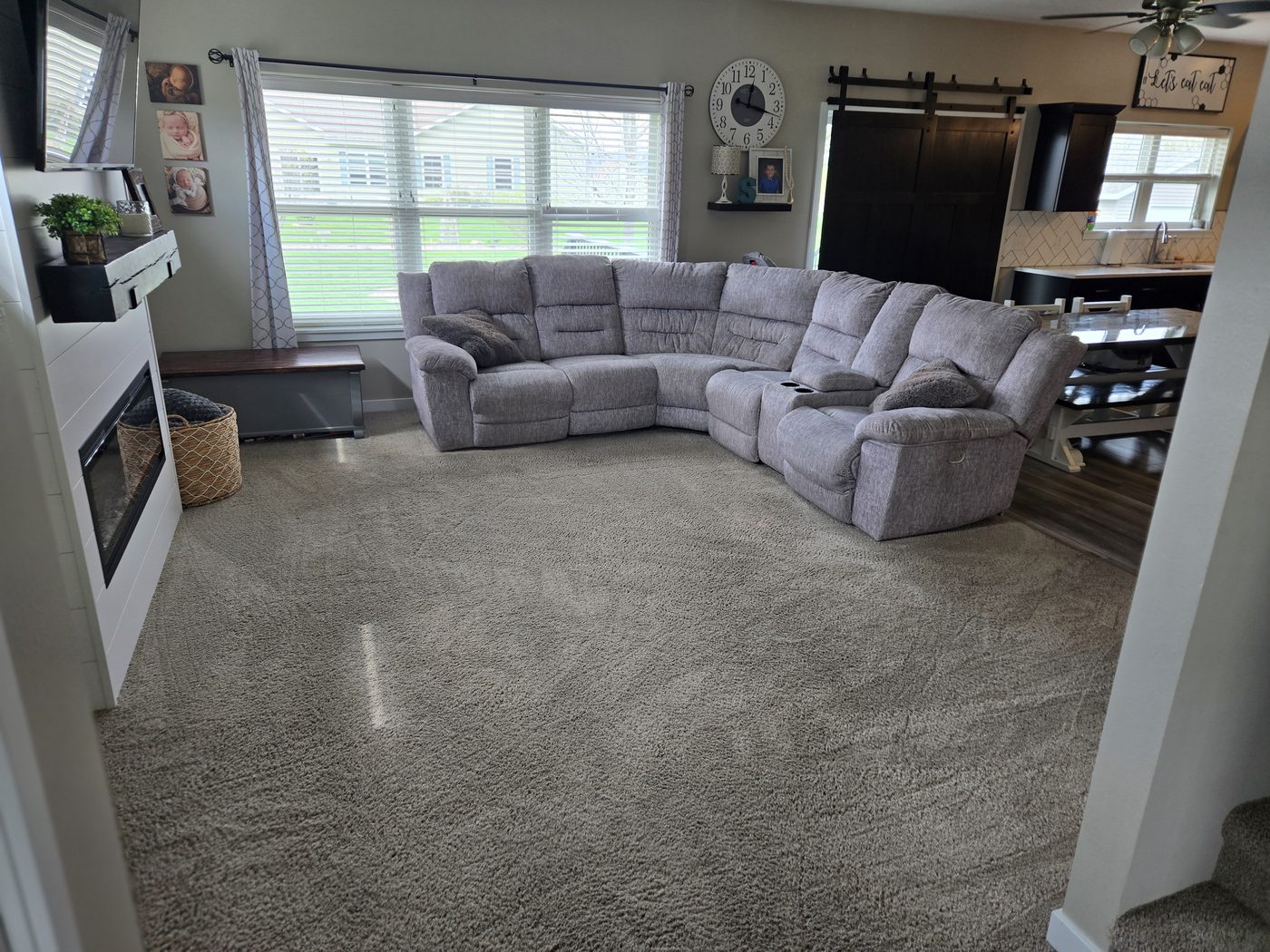 Open concept living room at 934 2nd Street Jesup Iowa - fireplace, barn door, sectional